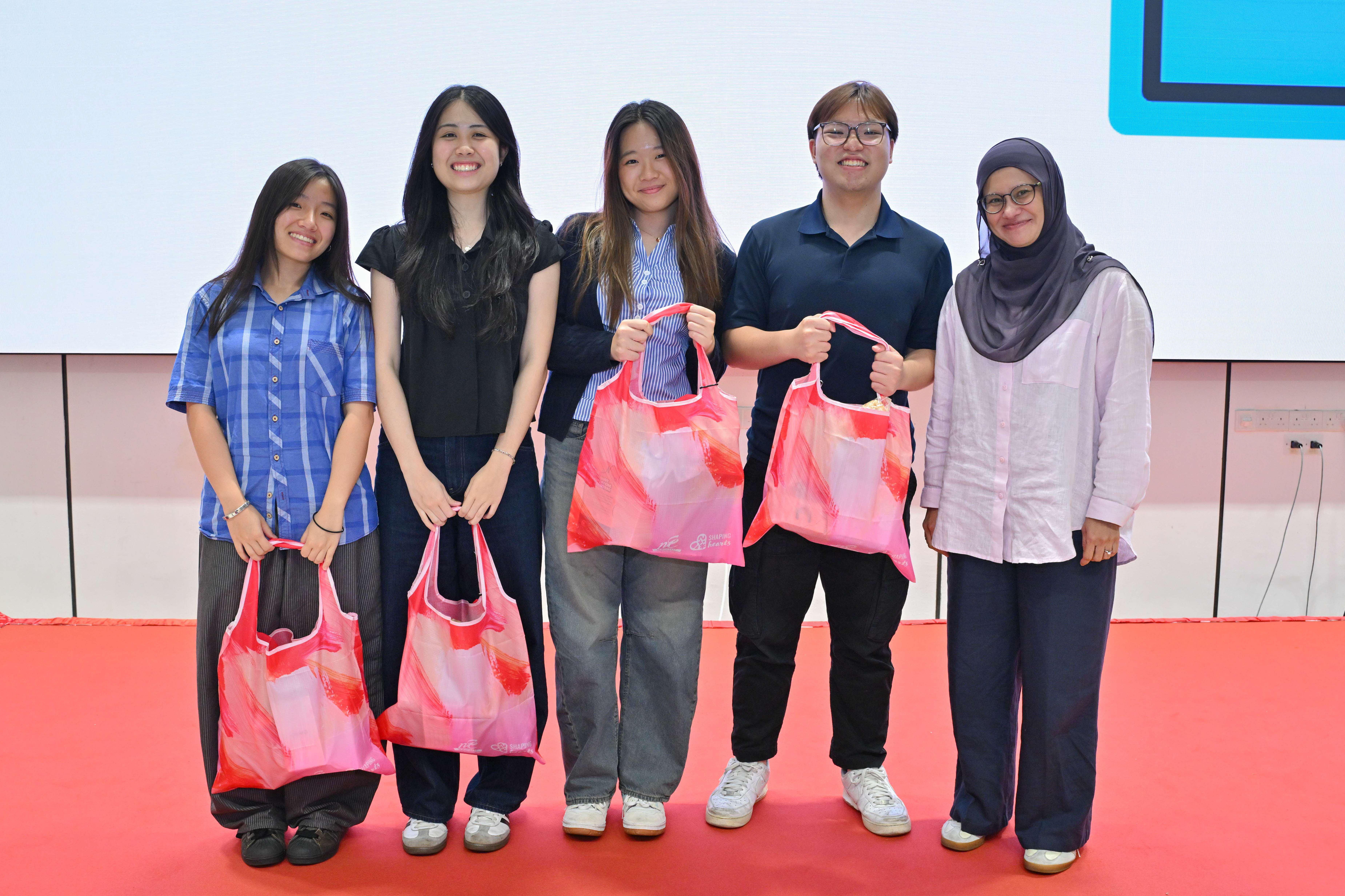 Winning students together with a panel judge excited